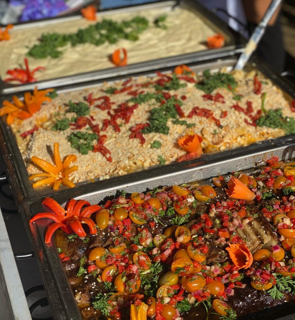 3 Trays of food decorated with colorful vegtables
