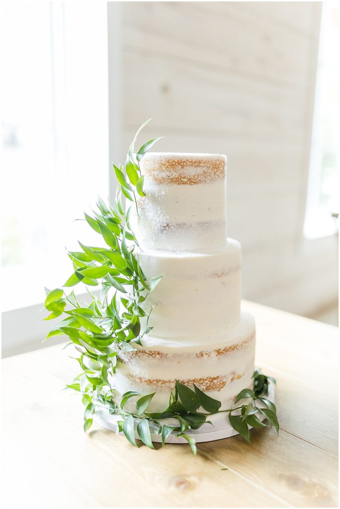 Naked style 3 tier wedding cake with greenery