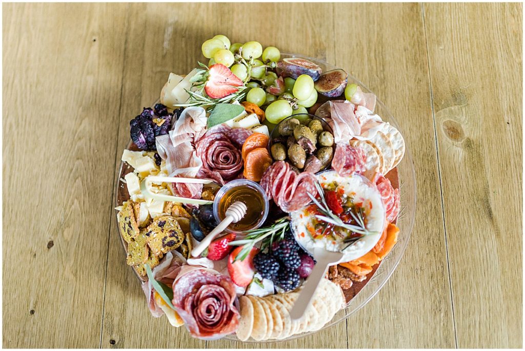 Charcuterie display with olives, fruit, meats, crackers and dips