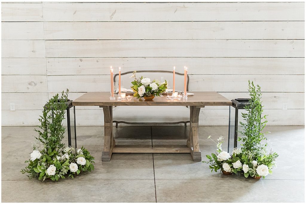 A sweetheart wedding table dressed up with candles and florals