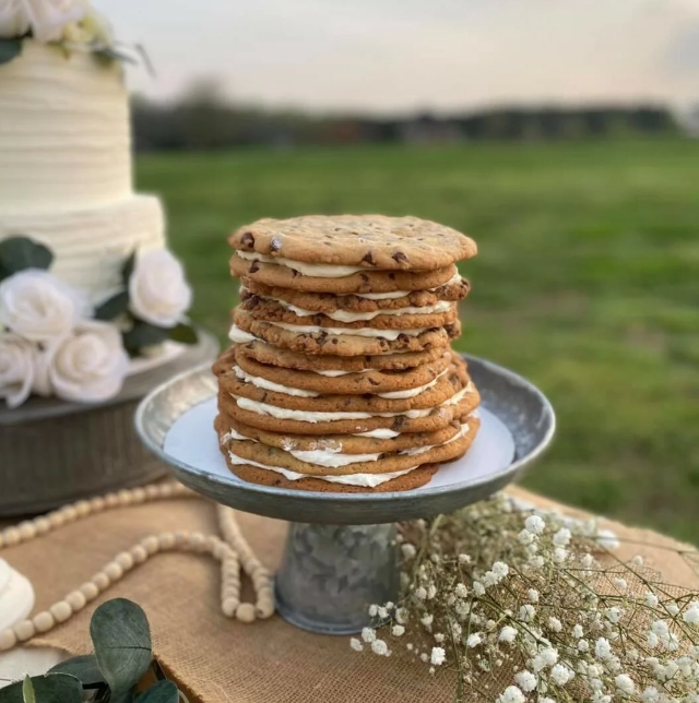 Cookies and cake on a wooden table with babies breath florals | Oh Sweet! Bakery in Georgia