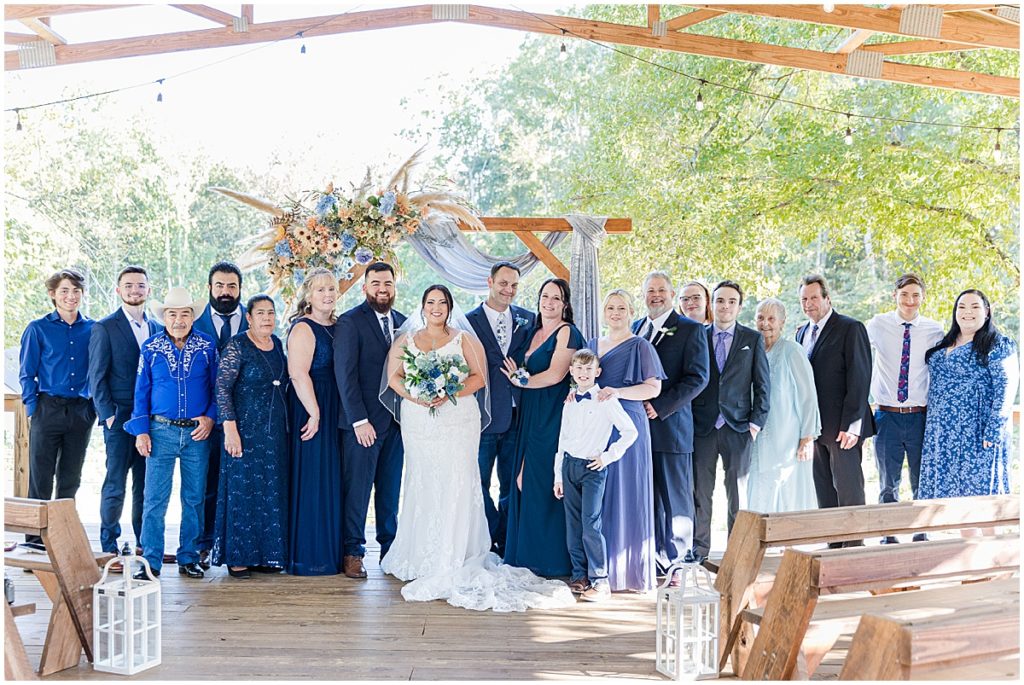 Wedding guests with bride and groom all dressed in shades of blue for this blue themed wedding in North Georgia.