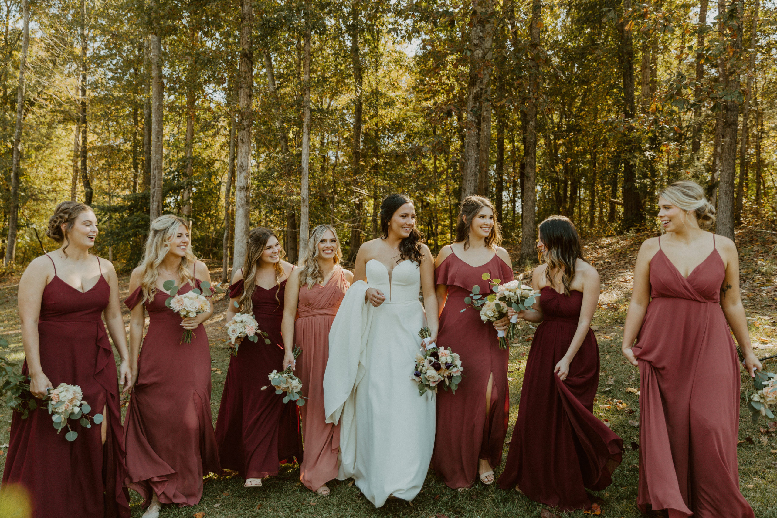 Brides with bridesmaids at rustic fall wedding