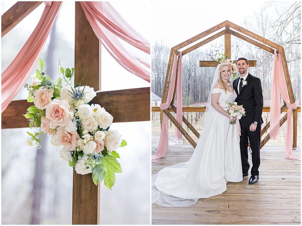 bride and groom at ceremony with cross and florals