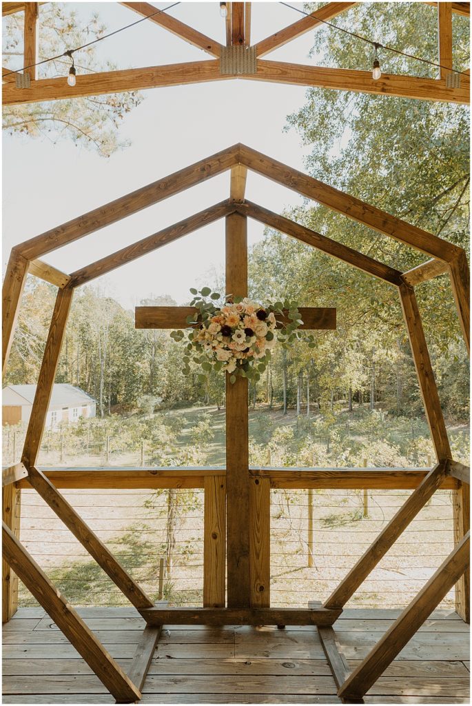 Wedding ceremony centerpiece cross and hexagon with floral display in center