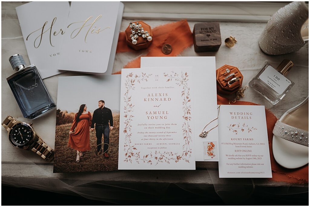 Wedding flatlay of wedding invites, vows. jewelry, shows and perfume for September wedding in North Georgia