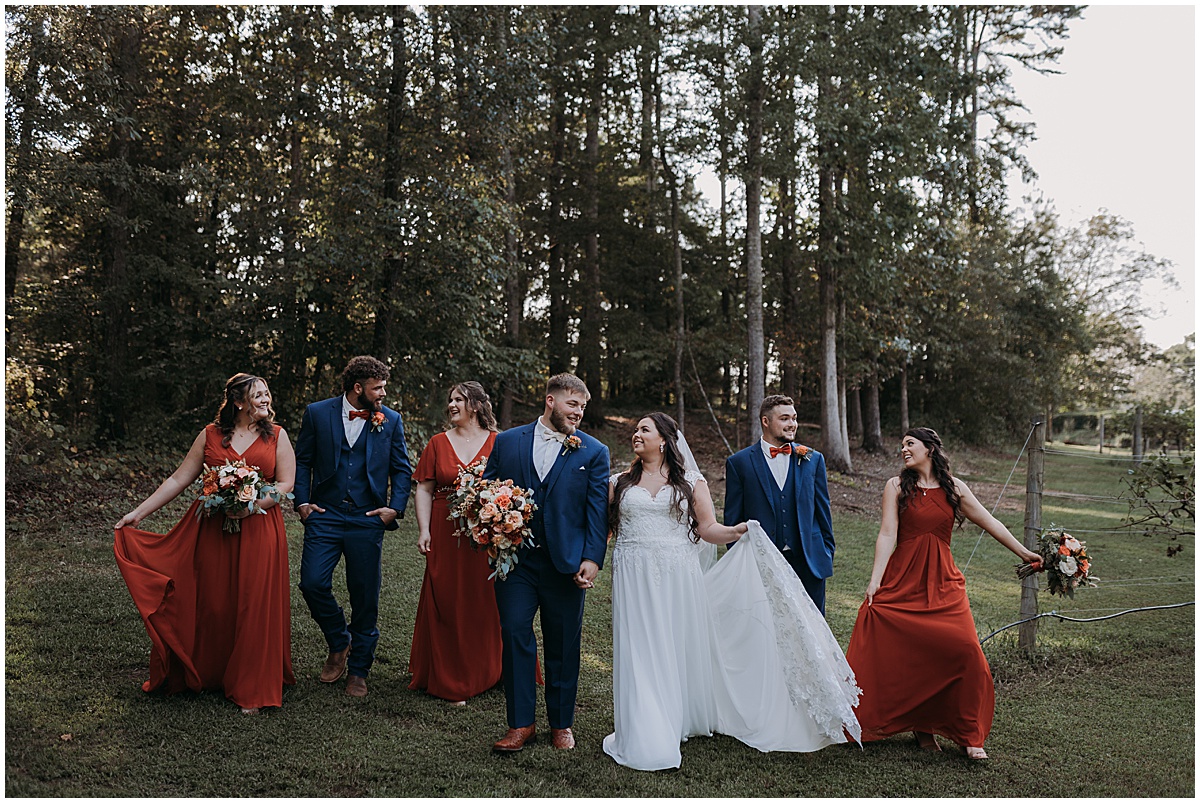 Bridal party wearing blue and burnt orange at September wedding in North Georgia