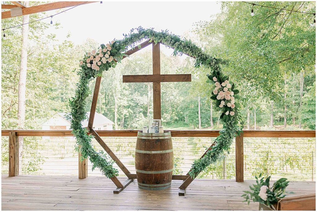 ceremony centerpiece with cross and greenery