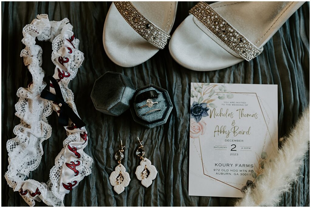 Bridal details for boho winter wedding including shoes, earrings and invitation