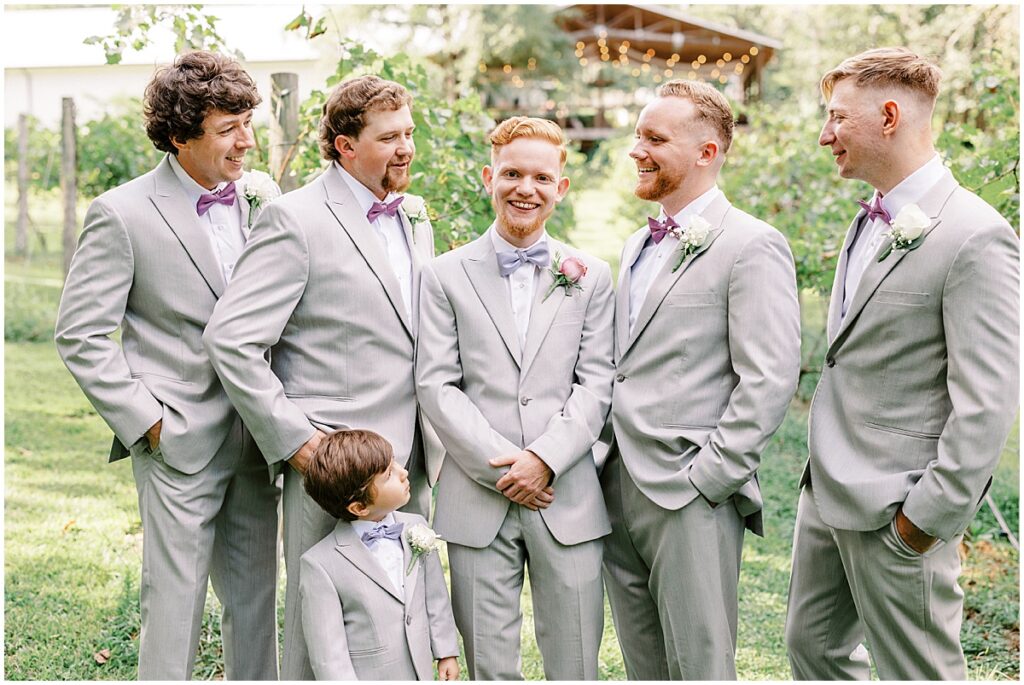 Groom with groomsmen in grey suits for wedding at koury farms
