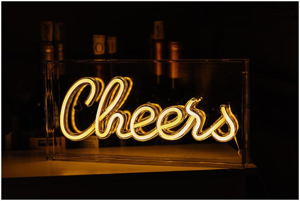 cheers sign illuminated at wedding reception