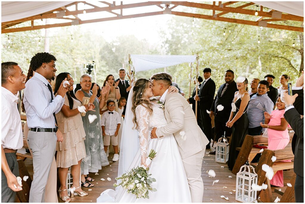 Bride and groom kissing after wedding ceremony at Koury Farms