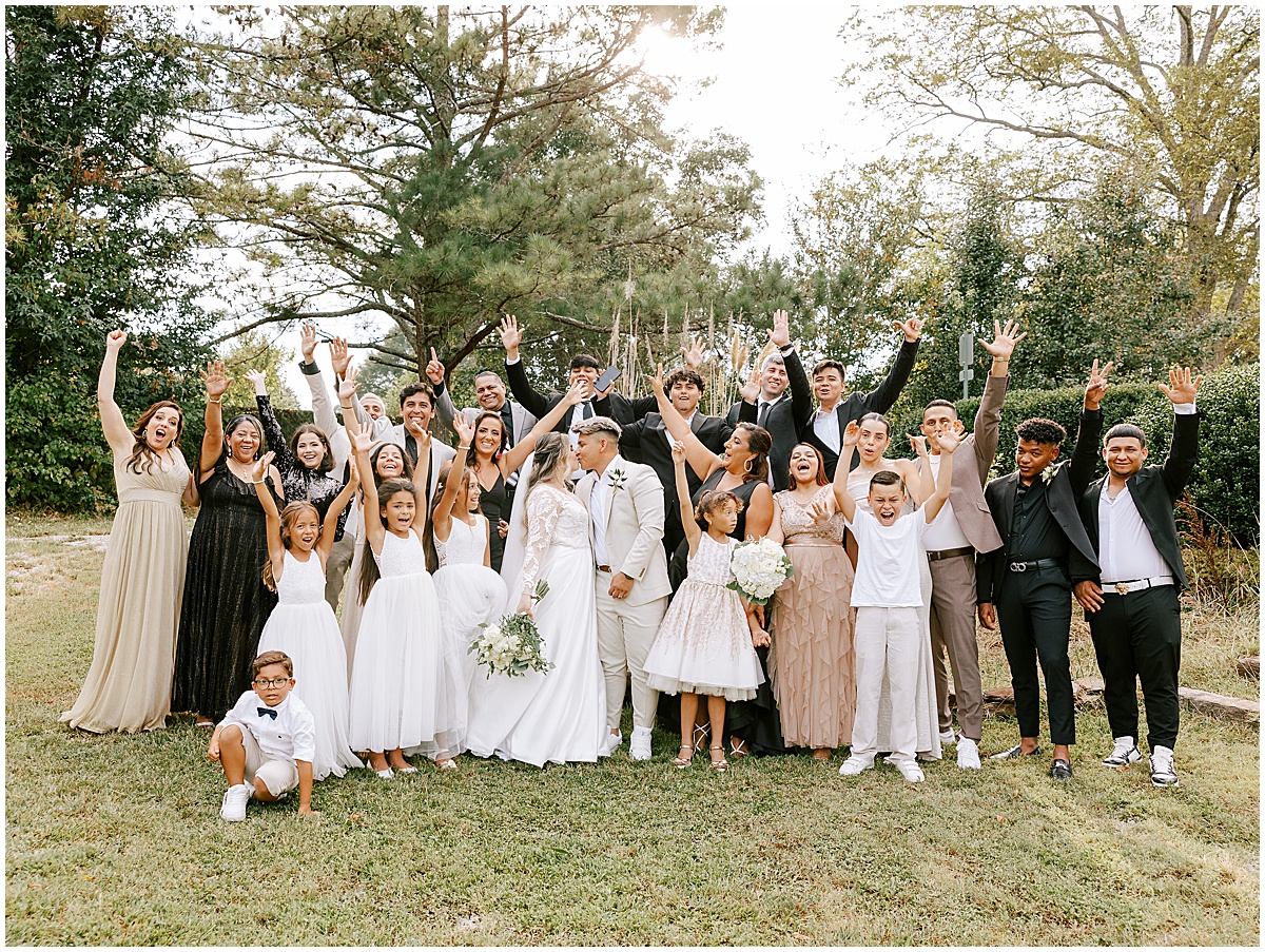 Wedding party wearing black white and champagne wedding outfits