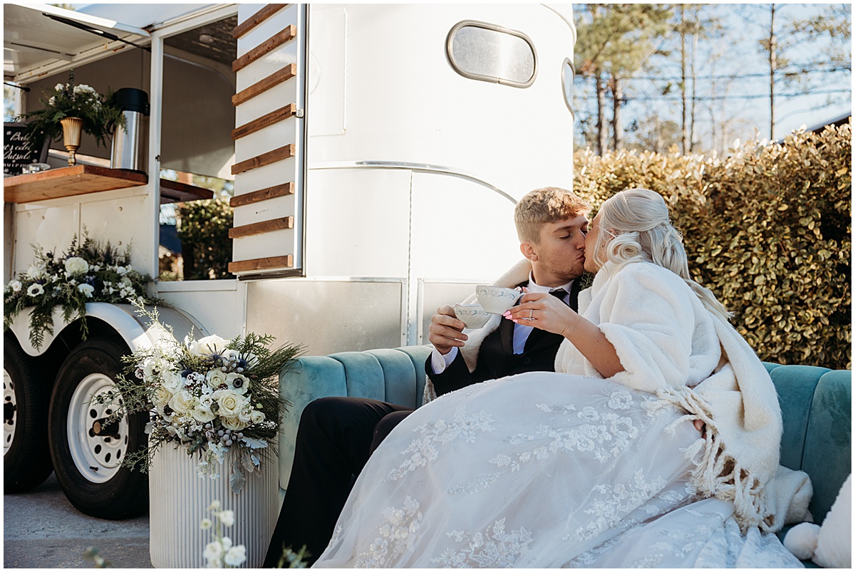 bride and groom enjoying hot chocolate from a mobile bar at winter wedding in North Georgia