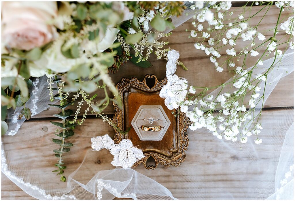 Rings and florals for olive, black and gold wedding