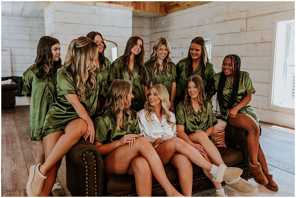 Bride surrounded by bridesmaids in olive green silk PJ's