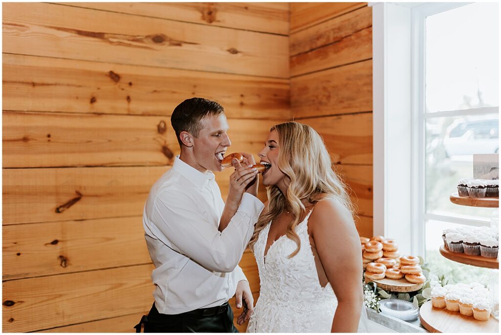 Bride and groom feeding each other at wedding reception