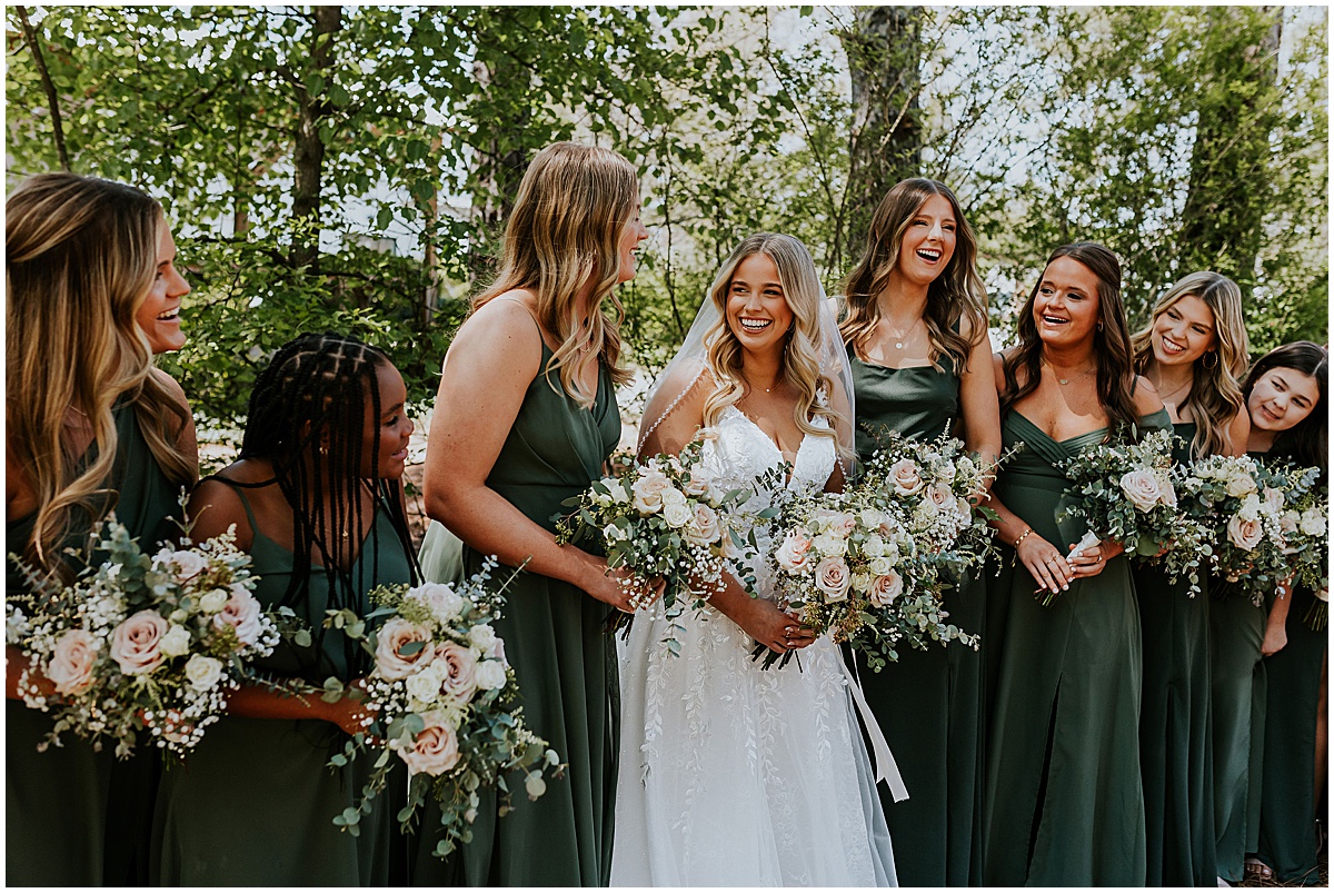 Bride with bridesmaids wearing olive green dresses