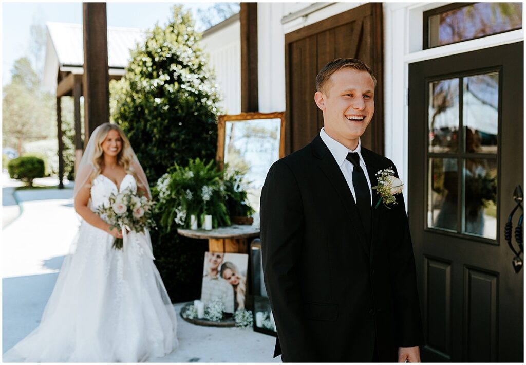 Bride and groom first look at olive, black and gold wedding