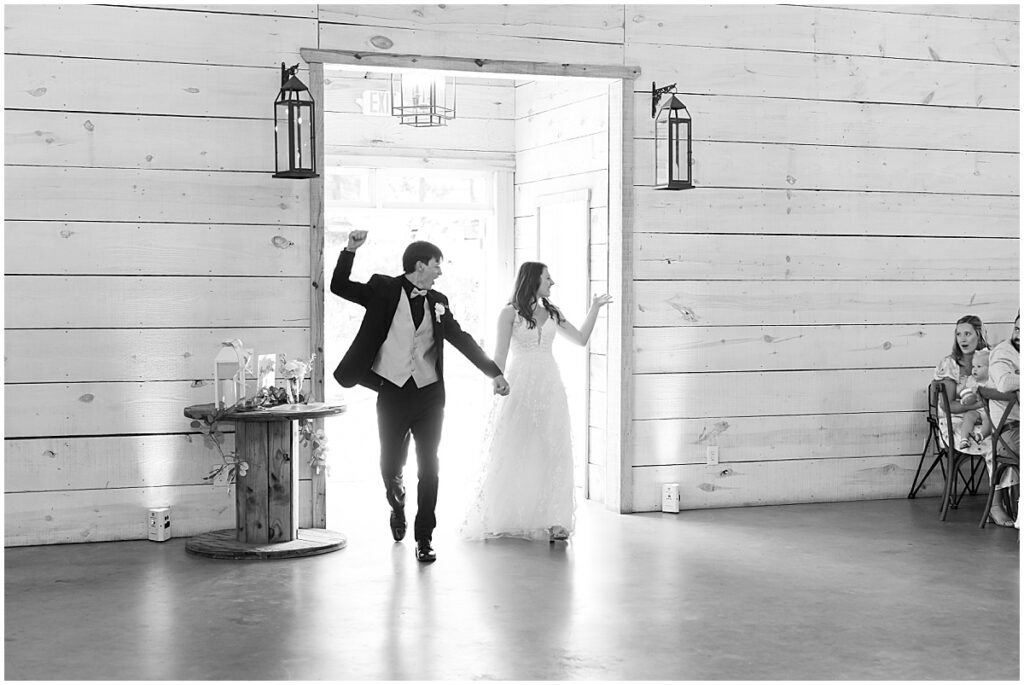 Bride and groom entering wedding reception