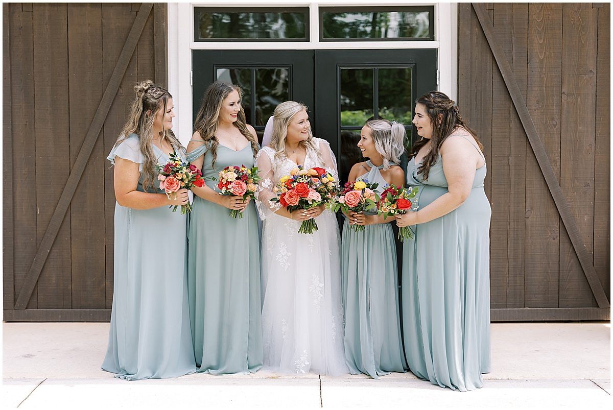 bride with bridesmaids wearing duck egg blue dresses