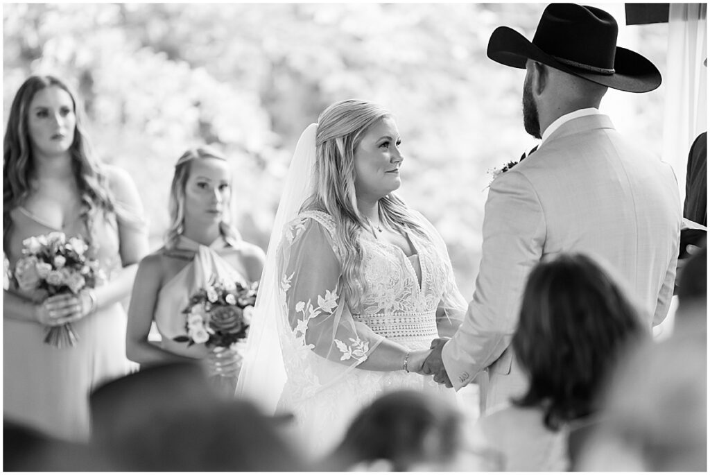 Bride and groom exchanging vows at rustic spring wedding