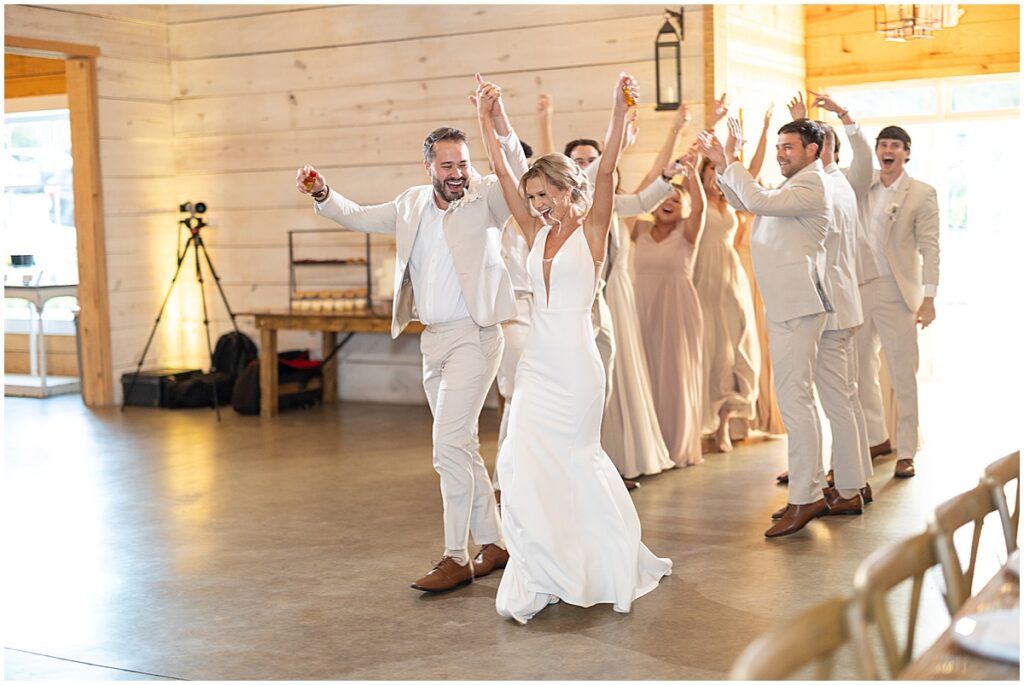 Bride and groom entering wedding reception at Koury Farms, neutral wedding color palette