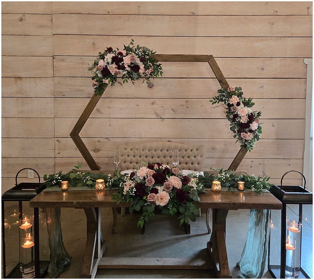 Wedding arch for background of sweetheart table by Flowerbox By B