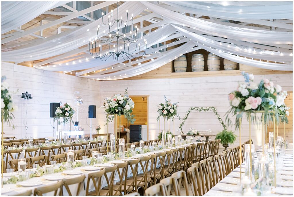 Wedding reception tables with high floral displays at Koury Farms