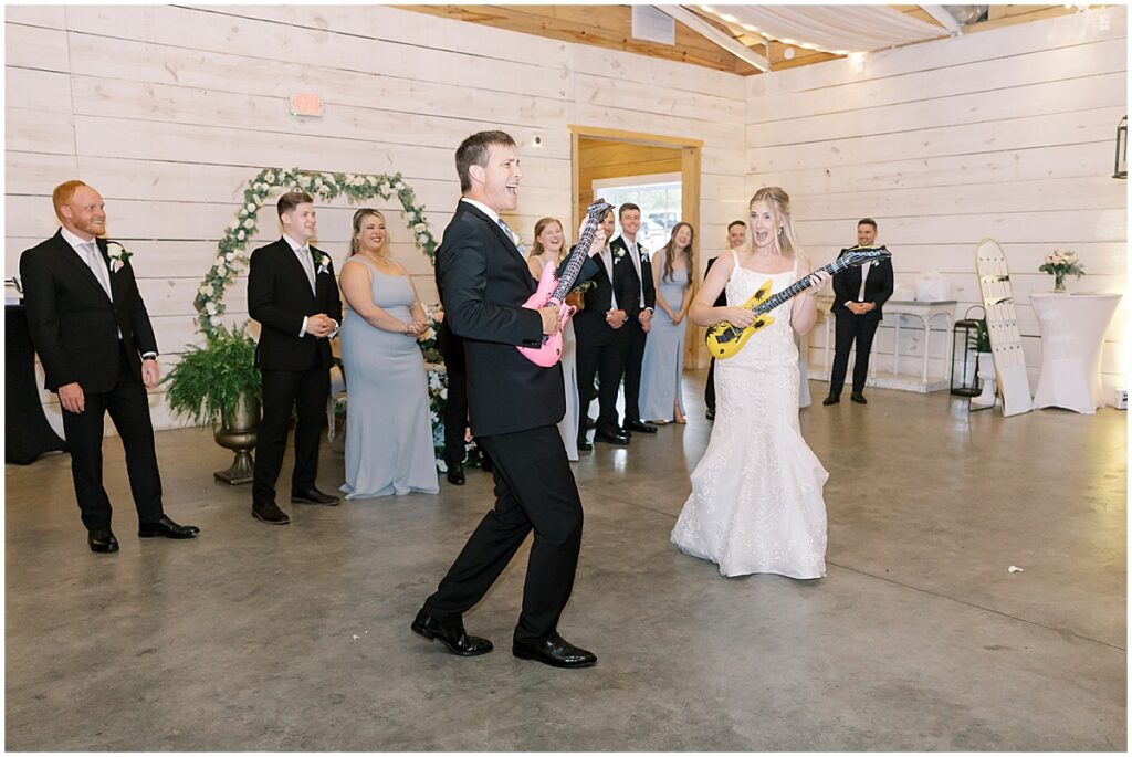 Bride playing guitar with her father at wedding reception at Koury Farms