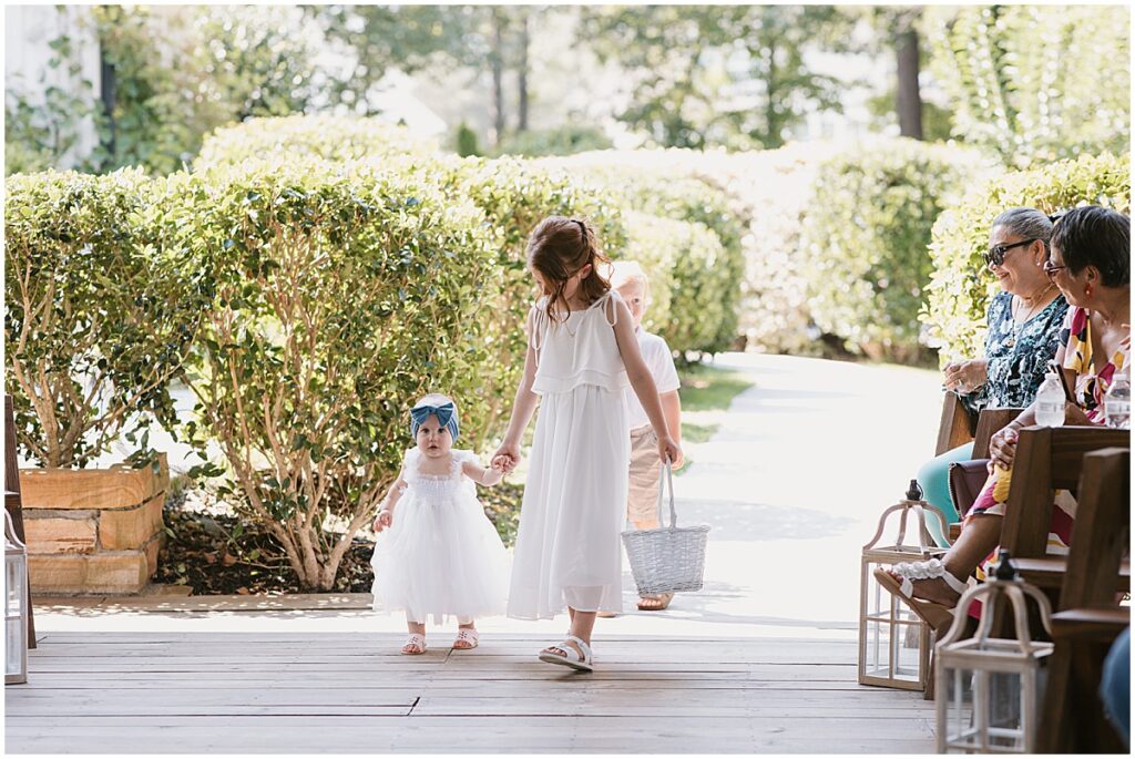 Young girl with toddler walking down the aisle for elegant fairytale wedding at Koury Farms