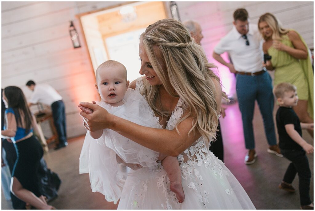 Bride dancing with her baby daughter at wedding reception