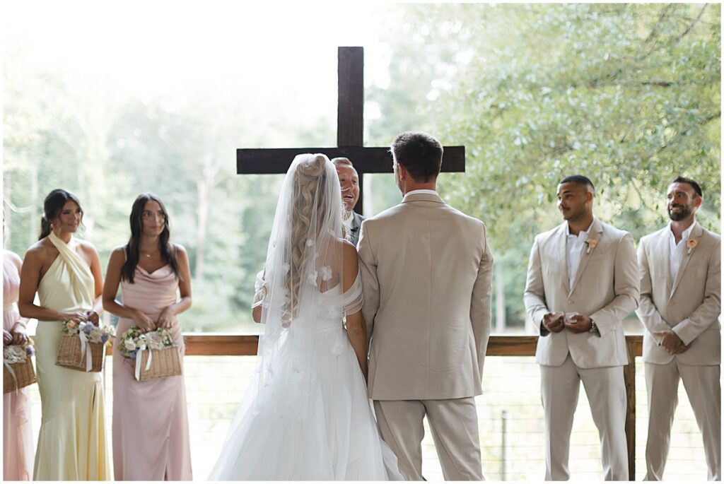 wedding ceremony at Koury Farms in front of wooden cross