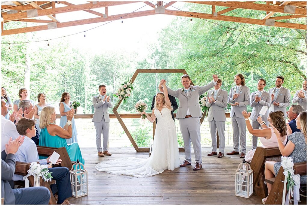 Wedding ceremony with bride and groom just married at Koury Farms