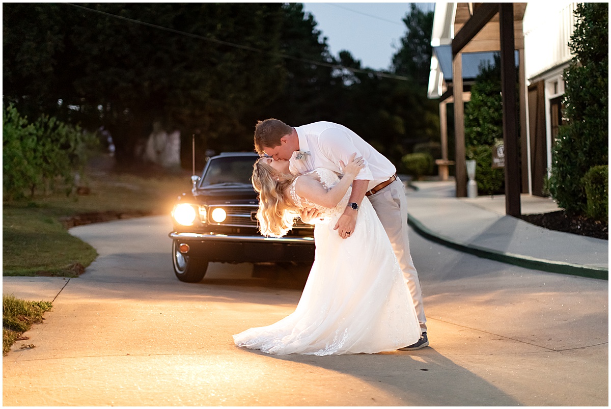 wedding portraits in front of vintage wedding getaway car