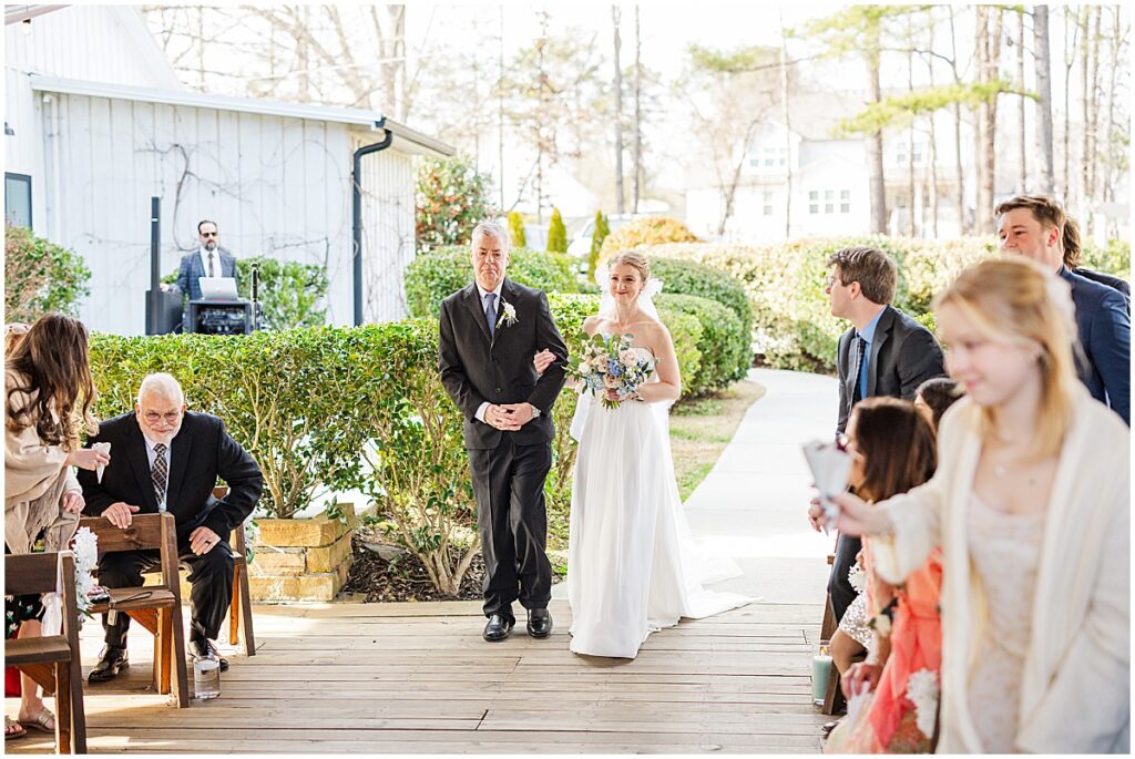 Bride and father walking down the aisle at March wedding at Koury Farms
