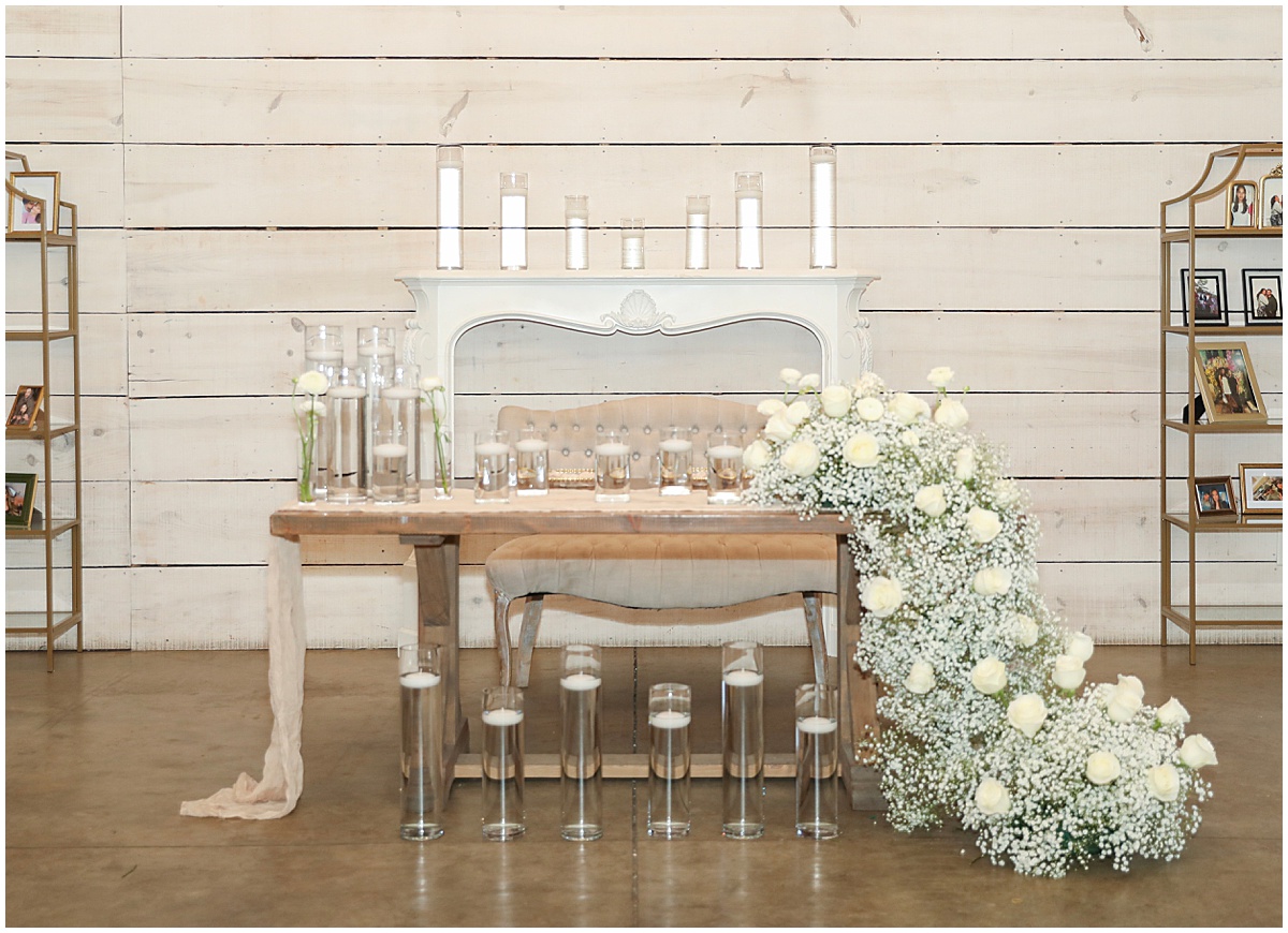 Sweetheart table with candles and cascading florals designed by devine floral studio
