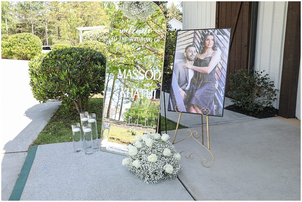 Photo, signage, candles and white roses and babies breath floral display