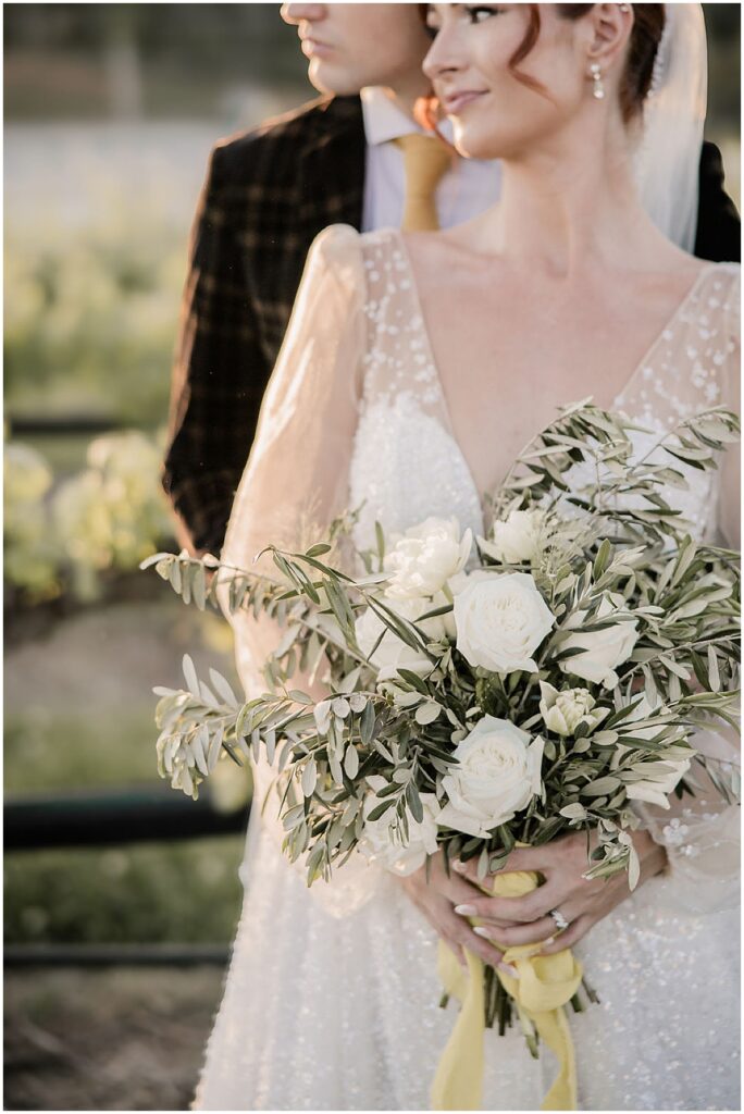 Bride holding bouquet of white florals