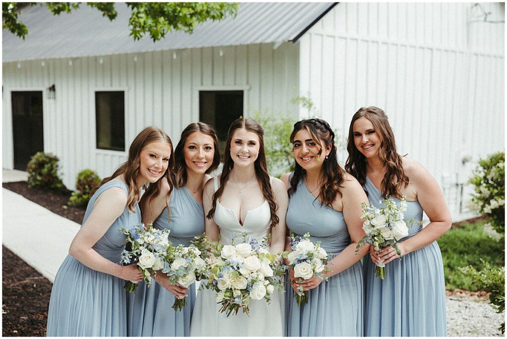 Bridesmaids holding bouquets at Koury farms wedding