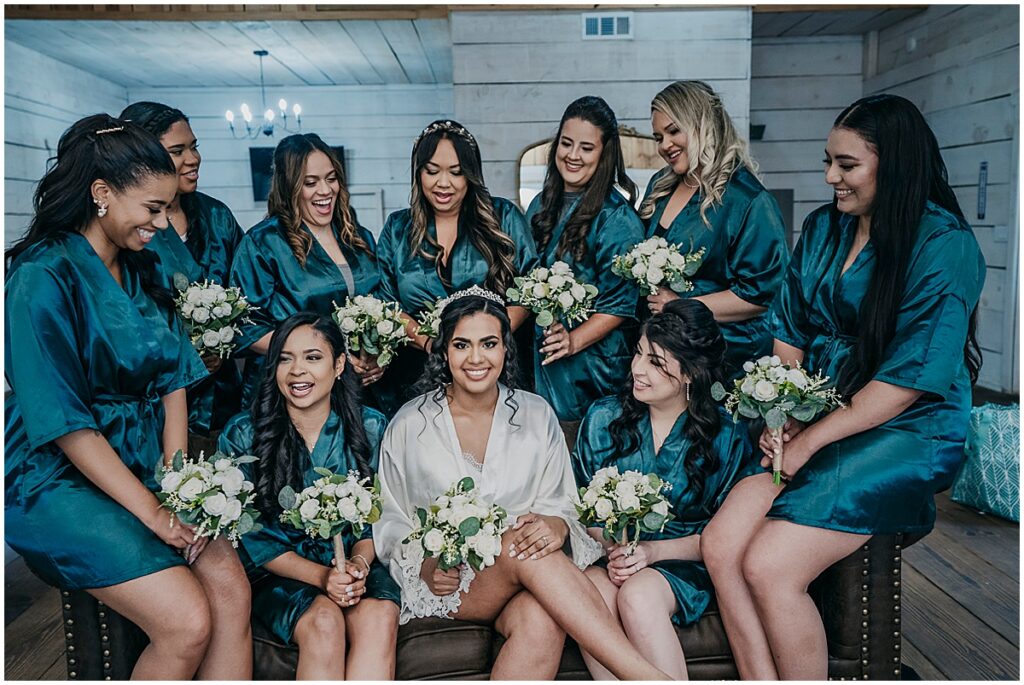 bride surrounded by bridesmaids in emerald greed robes