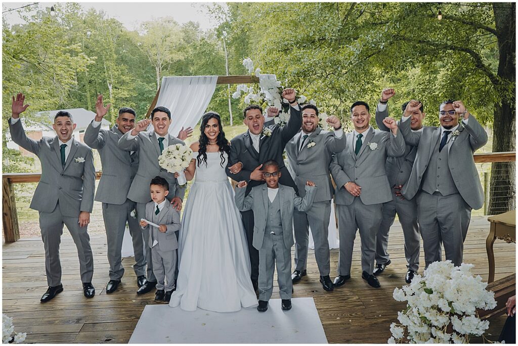 couple with groomsmen at koury farms weddingh