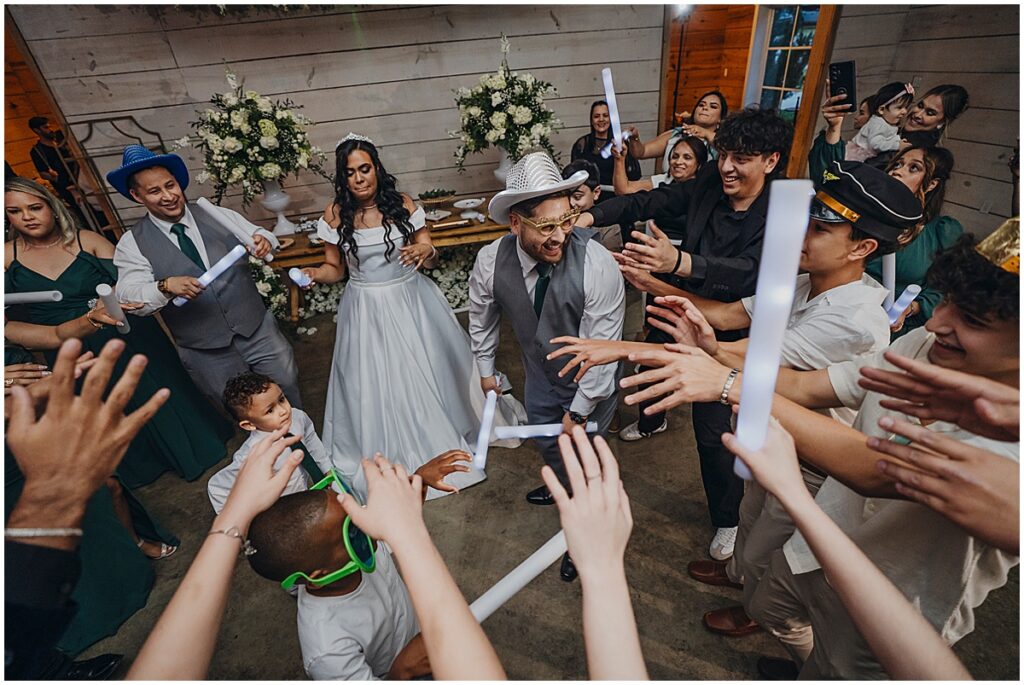 wedding guests dancing with glow sticks