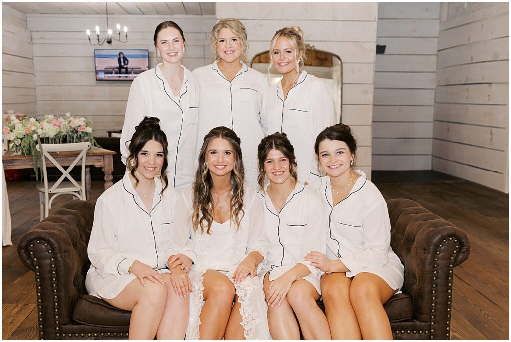 Bride with bridesmaids sitting on sofa in Bridal suite