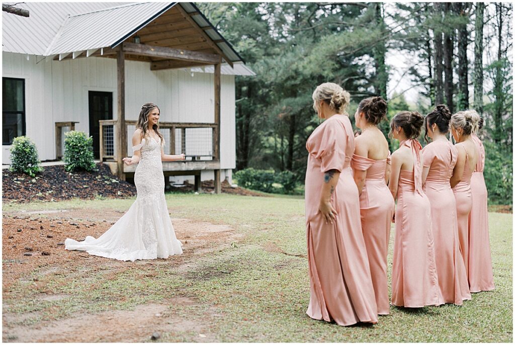 brides first look with bridesmaids in the grounds of Koury Farms