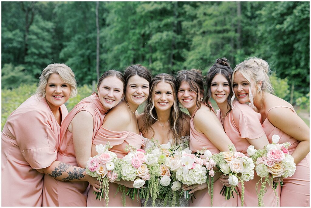 Bride with bridesmaids wearing blush dresses