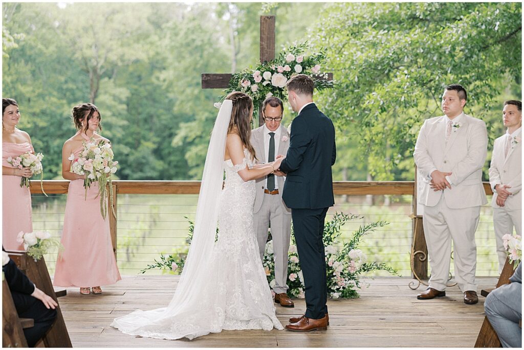 Wedding ceremony under the covered pavilion at Koury Farms with cross centerpiece