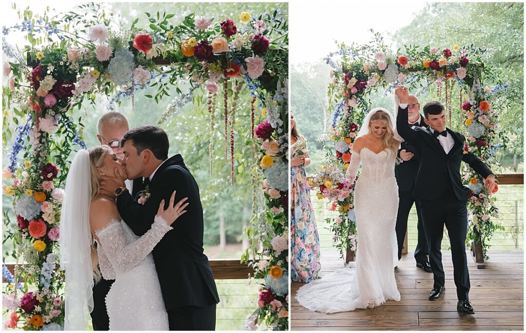 bride and groom kissing and holding hands up after wedding ceremony